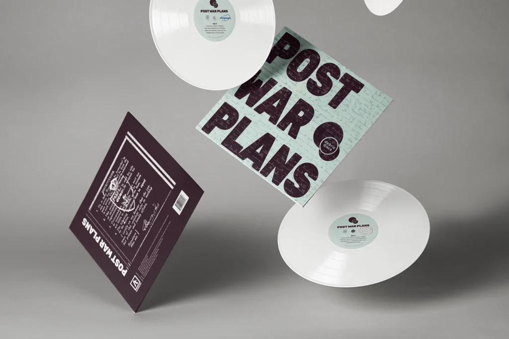 Two copies of Post War Plans album by Debris Discs falling through the air to show front, rear and vinyls