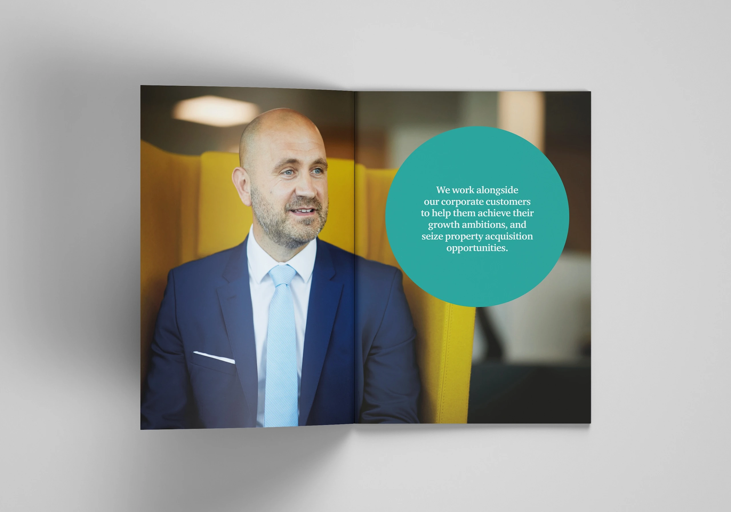 Inside spread of a corporate brochure designed by Gavin Stretch of Mode=Create showing an employees and copy reading 'We work alongside our corporate customers to help them achieve their growth ambitions, and seize acquisition opportunities.'