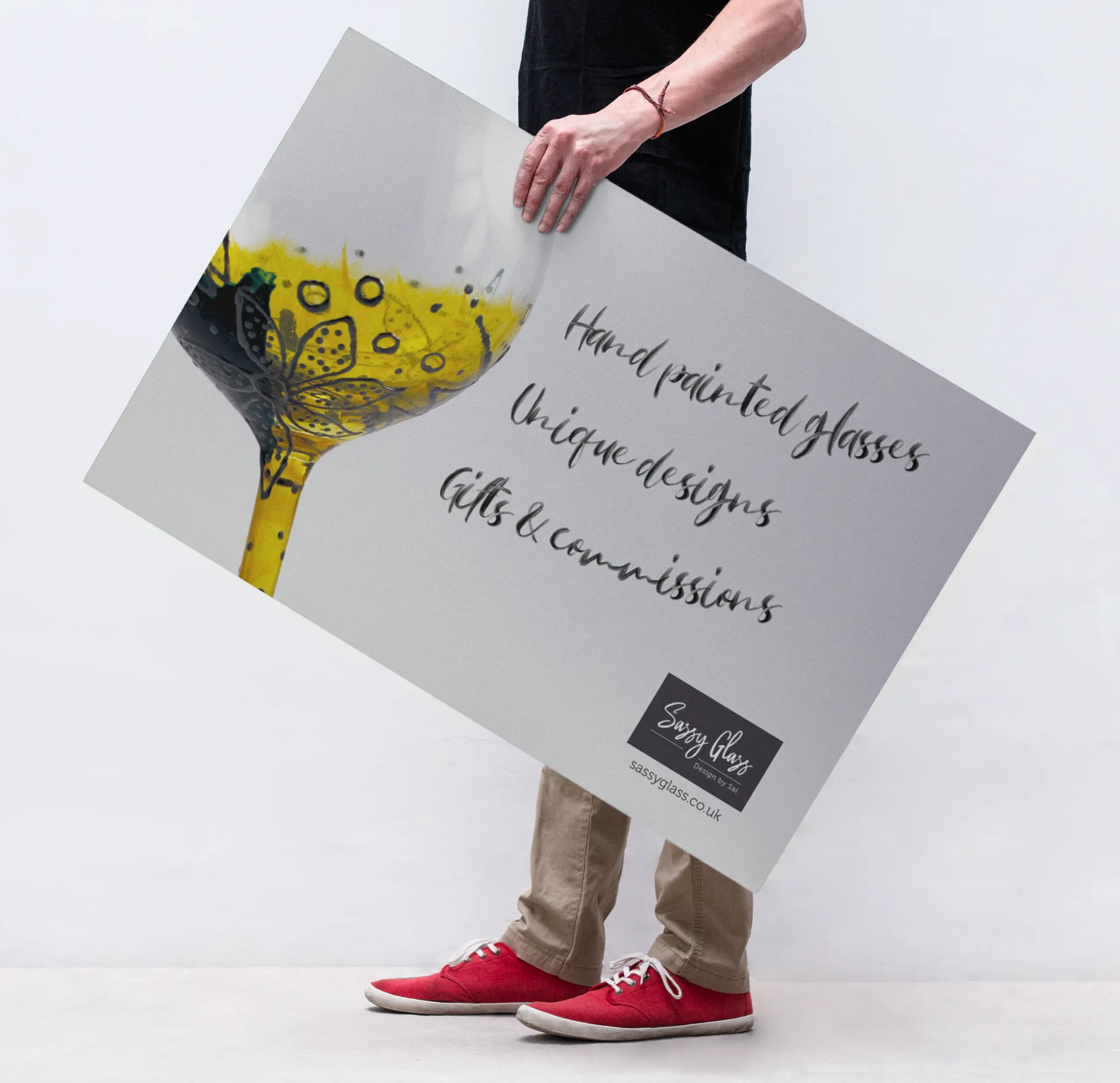 Man holding a Sassy Glass promotional poster designed by Gavin Stretch of Mode=Create.