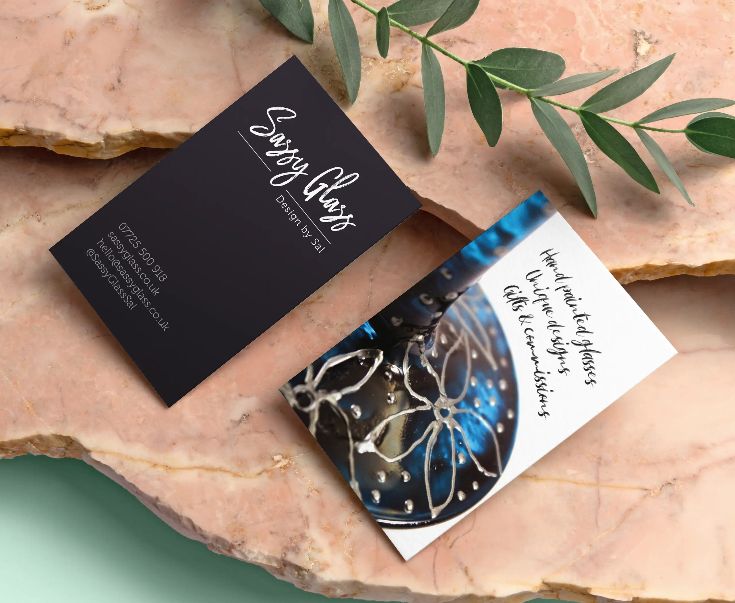 Sassy Glass promo cards designed by Gavin Stretch of Mode=Create on a stone plinth, front and rear of card shown respectively.